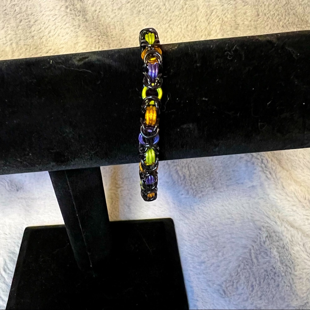 Black, purple, green, and orange chain mail bracelet